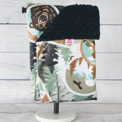 Black blanket with bears and trees