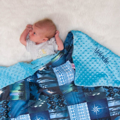 Baby girl with personalized blue blanket