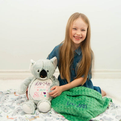 Girl with her personalized stuffed koala and matching blanket